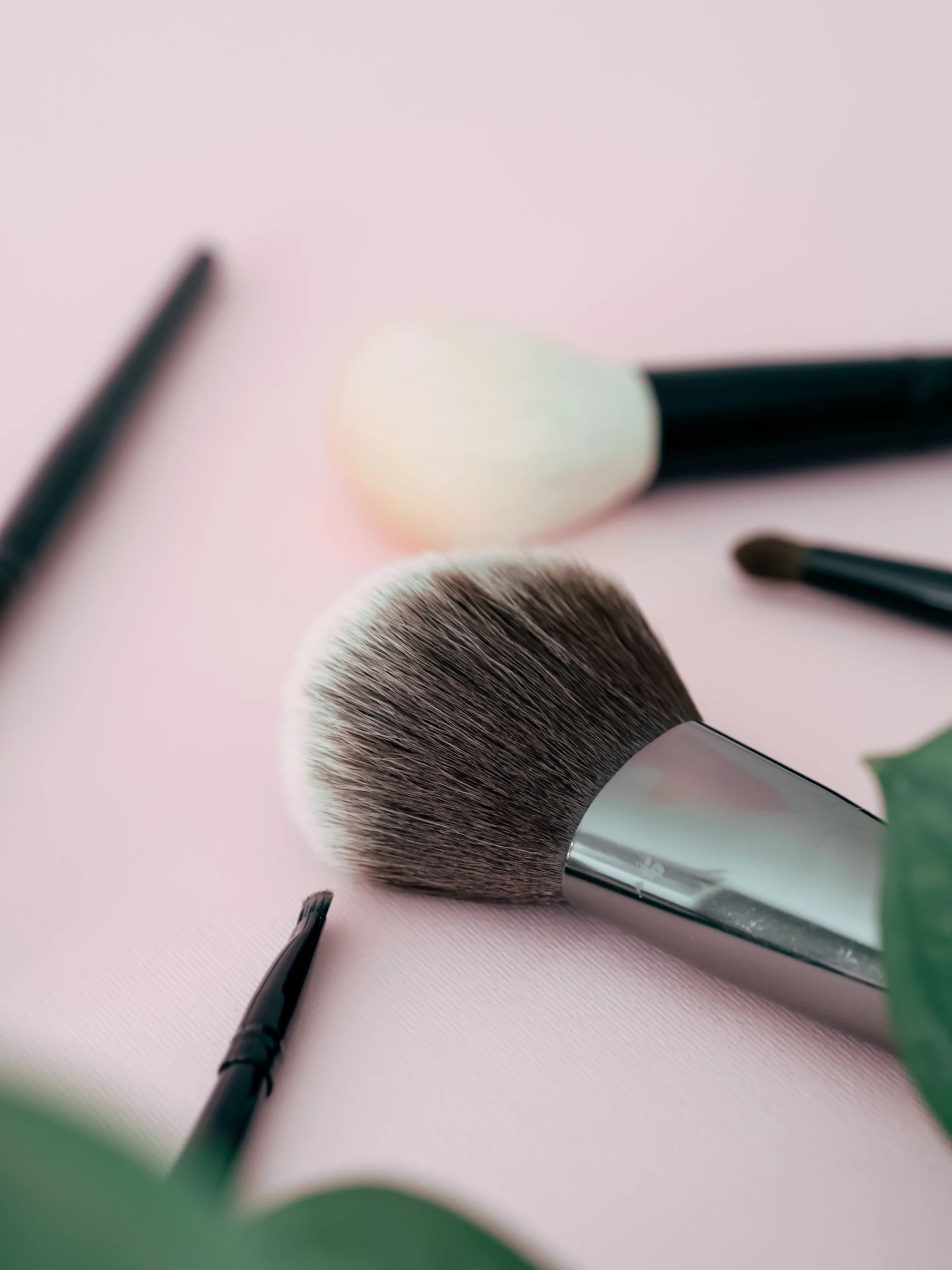 pink background with makeup brushes